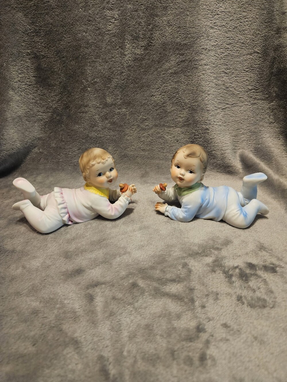 Vintage bisque porcelain piano babies. A boy and a girl.
